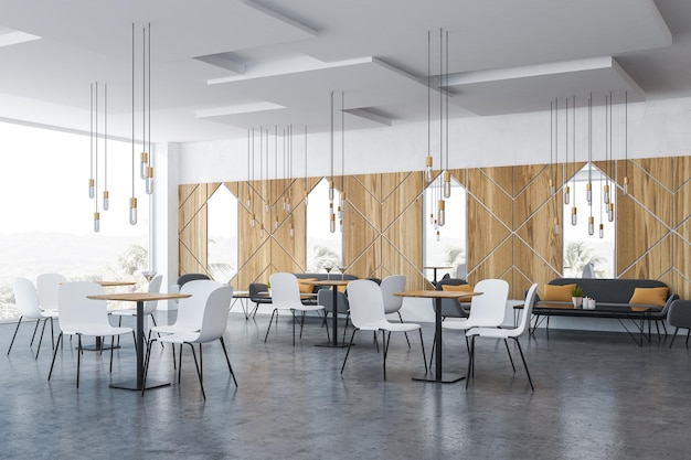 Corner of panoramic cafe with wooden walls, concrete floor, gray sofas and armchairs near coffee tables and white chairs near square tables. 3d rendering