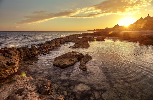 A corner of paradise: A natural pool in the middle of the rocks that make up the coast in the Mexican Caribbean at Puerto AVenturas at sunset.