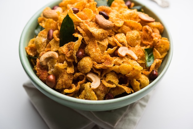 Cornflake Chivda or Corn Chiwda loaded with peanuts and Cashew. Served in a bowl. selective focus