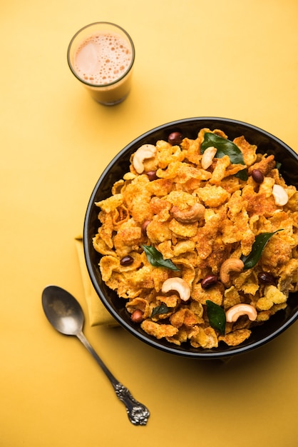 Cornflake Chivda or Corn Chiwda loaded with peanuts and Cashew. Served in a bowl. selective focus