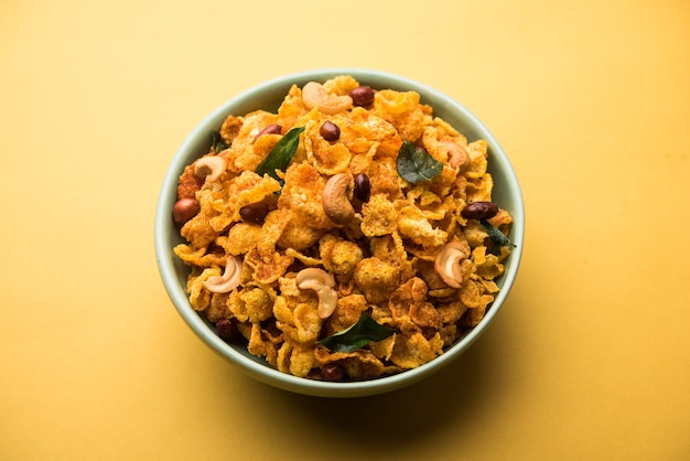 Cornflake Chivda or Corn Chiwda loaded with peanuts and Cashew. Served in a bowl. selective focus