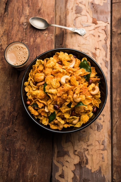 Cornflake Chivda or Corn Chiwda loaded with peanuts and Cashew. Served in a bowl. selective focus