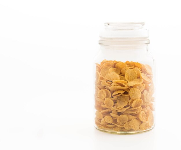 Photo cornflakes in bottle on white background