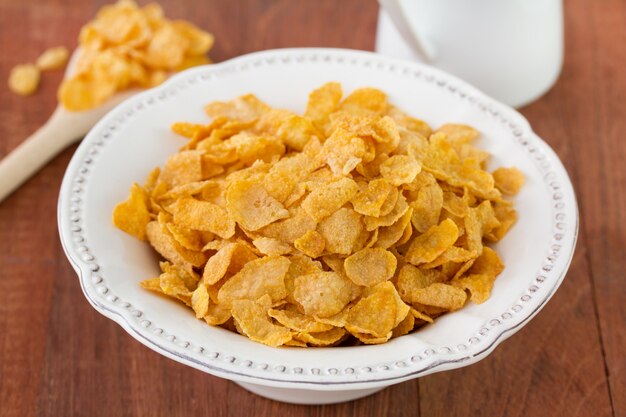 Cornflakes in witte schotel op bruine oppervlakte