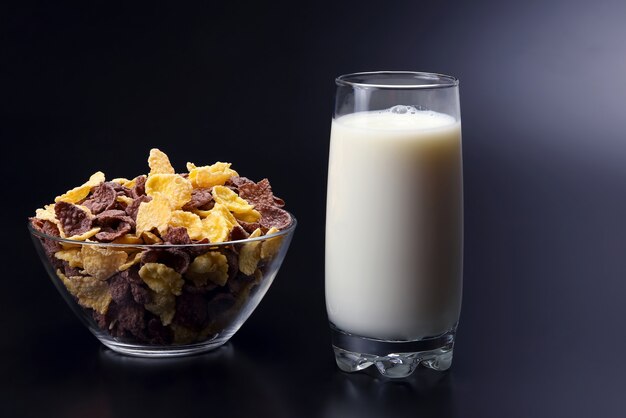 Cornflakes in a plate and a glass of milk
