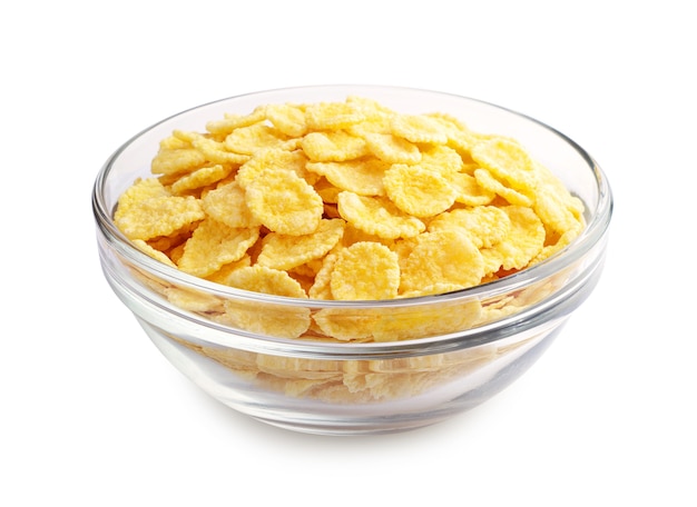 Cornflakes nella tazza trasparente su bianco