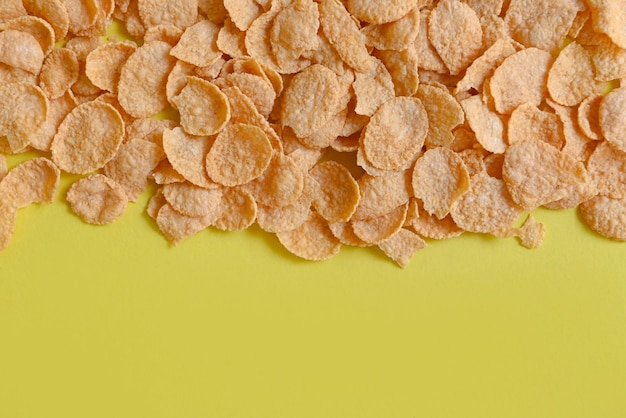 Cornflakes on yellow background cornflakes breakfast food and snack for healthy food concept morning breakfast fresh whole grain cereal