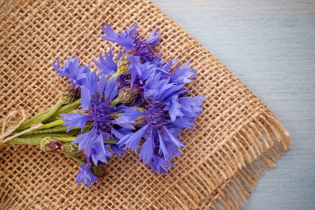 Cornflower on wooden background