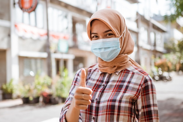 Coronavirus asian woman putting on a medical disposable mask to avoid viruses