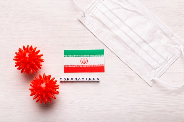 Coronavirus covid-19 concept. Top view protective breathing mask and flag of Iran. Novel Chinese Coronavirus outbreak.