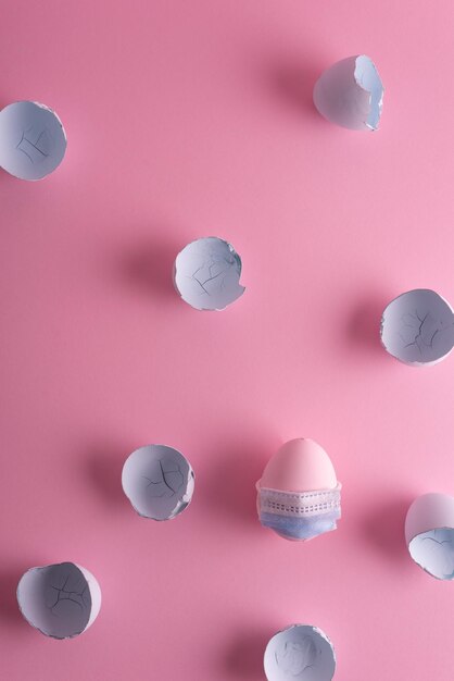 Coronavirus Easter egg in a protective mask concept painted in a pinkblue pastel shade eggshell Minimalistic easter coronavirus concept