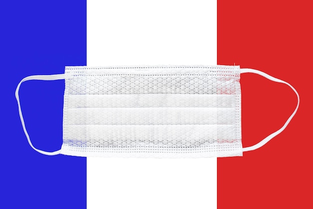 Coronavirus in France Medical mask on the background of the flag