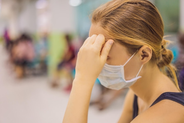 Coronavirus in the hospital covid woman in a medical mask patients in doctors waiting room