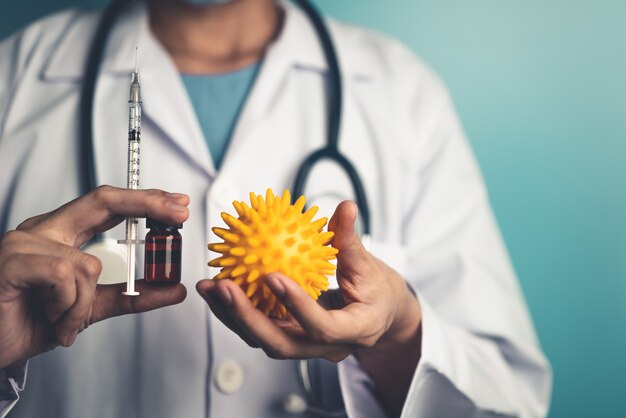 Coronavirus molecule model in the hands of a doctor