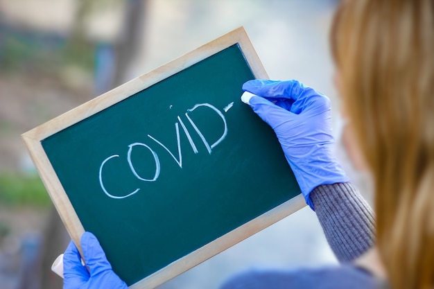 a coronavirus outbreak of the corona virus. epidemic viral respiratory syndrome. girl's plate in hands. china