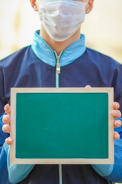 A Coronavirus Outbreak of the corona virus. Epidemic Viral Respiratory Syndrome. Plate in Man's Hands China