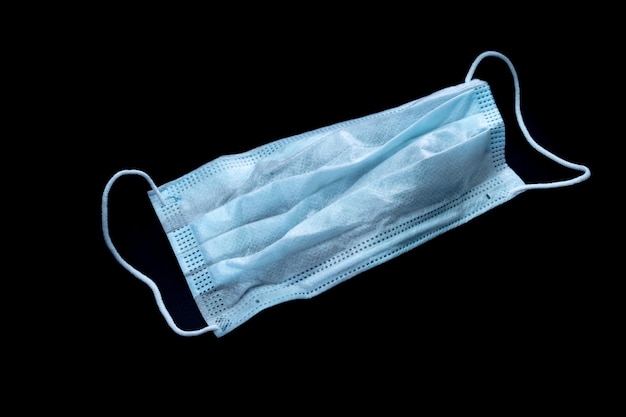 coronavirus. protective mask on black