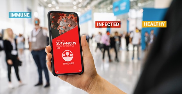 coronavirus tracking app on a mobile smartphone. Close up of woman tracking crowd of people in a smartphone screen application. Hand holding smart device. Mockup website. covid-19 corona virus tracker