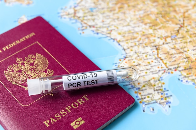 Coronavirus travel and test concept tube for covid19 pcr testing and passport on tourist map