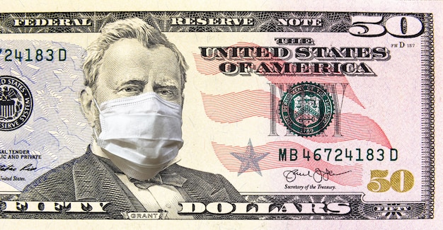 米国のコロナウイルス フェイスマスク付きの50ドル紙幣 COVID19は世界の株式市場に影響を与える コロナウイルスのパンデミックの恐れに見舞われた世界経済