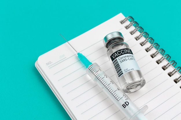 Photo coronavirus vaccination background with vaccine vial and medical syringe, medicine and healthcare cure concept photo