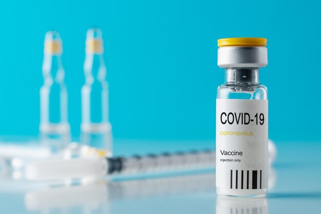 Coronavirus vaccine vial glass with a syringe