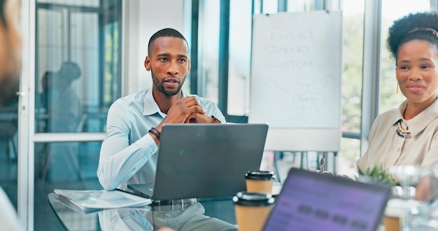 Photo corporate black man and team in meeting brainstorming and feedback for new project discussion and planning staff african american male leader and employees share ideas collaboration and talking