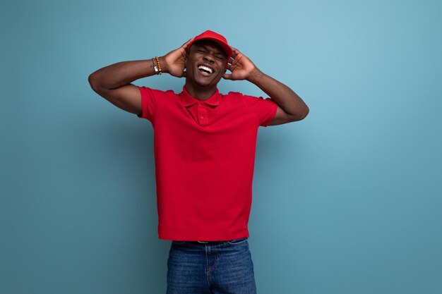 corporate color handsome african man wearing red tshirt and cap on background with copy space