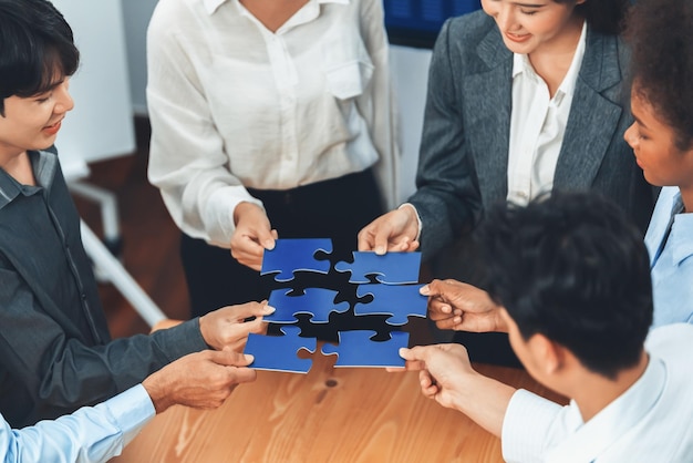 Corporate officer workers connecting puzzle pieces on table Concord