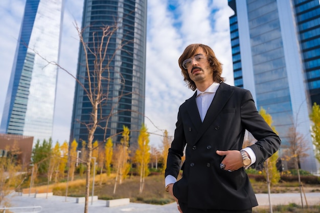 Corporate portrait of alternative businessman business park boss outside offices