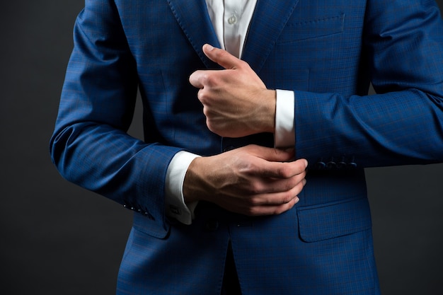 Correct sleeve length. Every detail matters. Jacket perfect fit. Business style formal dress code. Male hands adjusting business suit close up. Formal style. Business people choose formal clothing.