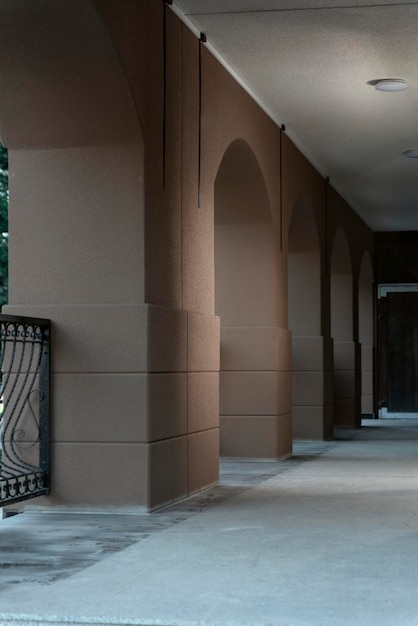 Corridor with arches. Arcade in the construction of modern buildings. Architecture of the 21st century. Vertical frame.