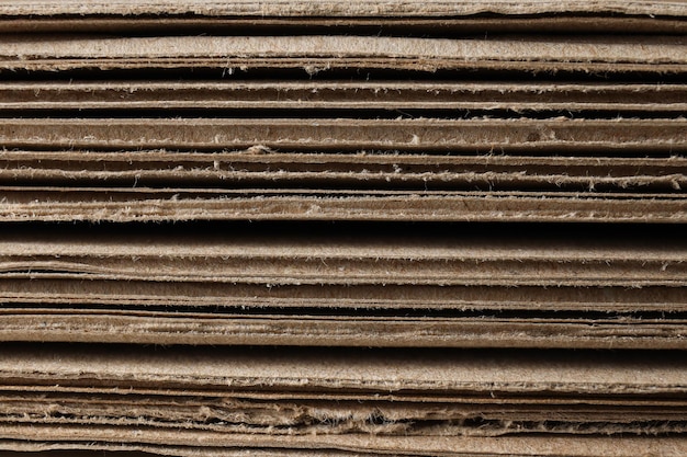 Corrugated cardboard on the table is laid out in layers