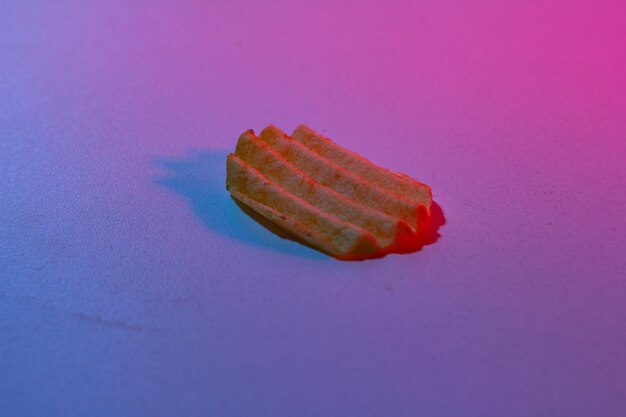 Corrugated chips in neon light on a white background