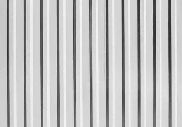 Corrugated metal fence Metal profile fence in black and white Texture of ribbed metal sheets