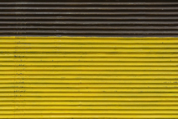Photo corrugated yellow and brown painted metallic background