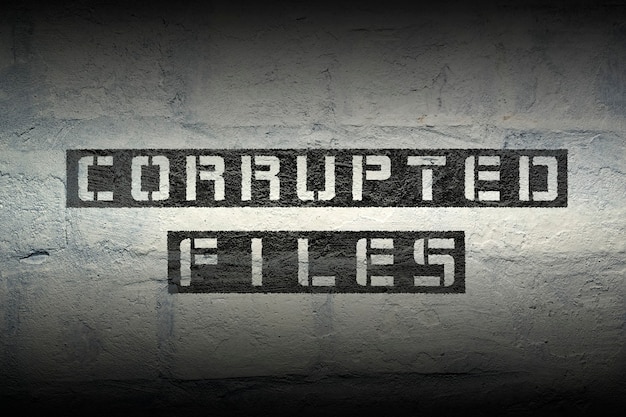 Corrupted files phrase stencil print on the grunge white brick wall