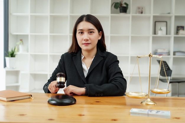 Corruption concept law female lawyer holding a gavel showing justice during work