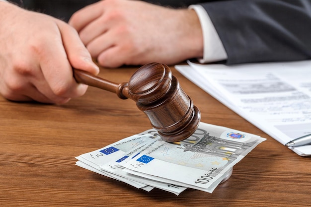 Corruption money euro gavel hammer lawsuit authority