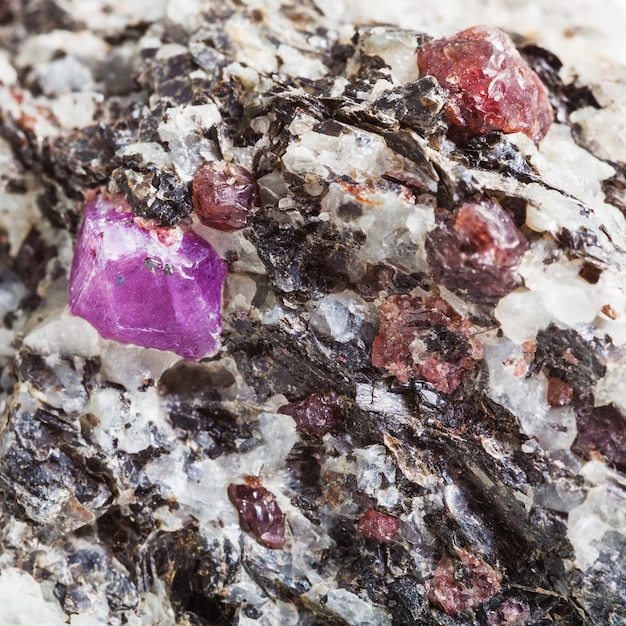 Corundum crystals in mineral stone close up