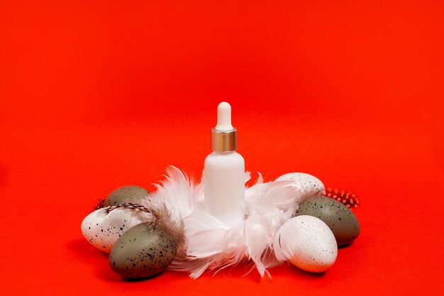 Cosmeric white bottle with essential oil or serum in the nest with easter eggs bright red backgrund