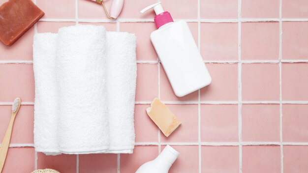 Photo cosmetic beauty products on pink background bottles and tubes with branding mock up