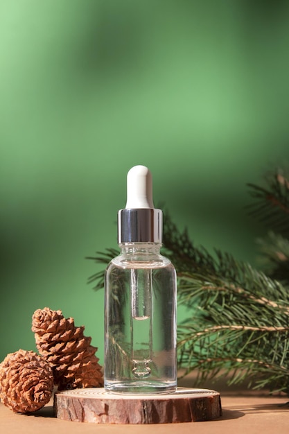 Cosmetic bottle between fir branches and pine cones Skin care cosmetic