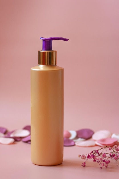 cosmetic bottle on pink background