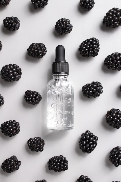 Cosmetic bottle of serum and blackberries Essential oil collagen serum for beauty Cosmetics with natural ingredients