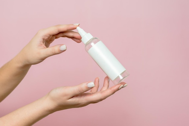 Cosmetic bottle in woman's hands Cosmetic product branding mockup Spa beauty treatment concept