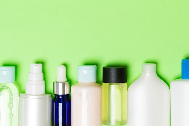 Cosmetic bottles on a colored background