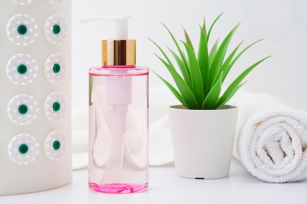 Cosmetic bottles and white towel on table empty space background.Shower items set.Spa objects.Face and body care products.Bathroom tubes. High quality photo