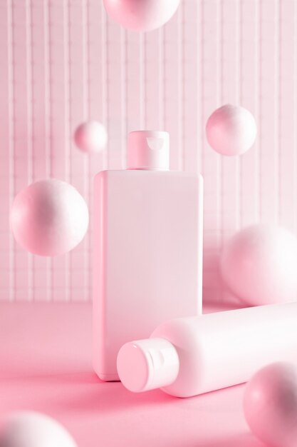 Photo cosmetic bottles with flying balls in a pink neon light, mock up