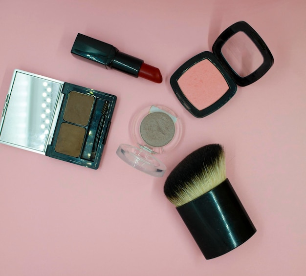Premium Photo Cosmetic brush blush red lipstick and eye shadow